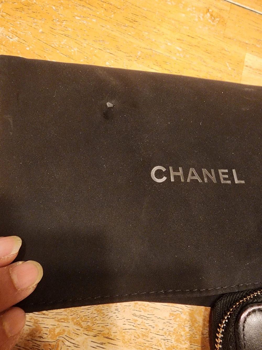 Chanel Timeless CC zip-around wallet features smooth black leather
